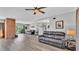 Expansive living area with hardwood flooring, brick fireplace, comfortable seating, and stylish decor at 1854 Sherwood Lakes Blvd, Lakeland, FL 33809