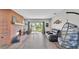 Spacious living room featuring a brick fireplace, sliding glass doors to the backyard, and modern furnishings at 1854 Sherwood Lakes Blvd, Lakeland, FL 33809