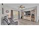 Comfortable living room featuring a large window, ceiling fan, and built-in shelving for storage at 1854 Sherwood Lakes Blvd, Lakeland, FL 33809
