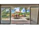 Covered patio with outdoor dining set and view of the lake beyond sliding glass doors at 1854 Sherwood Lakes Blvd, Lakeland, FL 33809