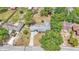 An aerial perspective of a home with a trampoline, tree coverage and a long driveway at 1965 Avenue F Sw, Winter Haven, FL 33880