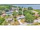 Aerial view of home with a lake view, trampoline, and lush green landscaping at 1965 Avenue F Sw, Winter Haven, FL 33880