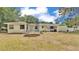 Expansive backyard features a trampoline and ample green space, perfect for outdoor activities and Gathering fun at 1965 Avenue F Sw, Winter Haven, FL 33880