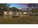 Exterior view of a yellow home with a backyard, including a trampoline at 1965 Avenue F Sw, Winter Haven, FL 33880