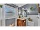 Charming bathroom with wood vanity, decorative mirror, wreath, and bright window at 1965 Avenue F Sw, Winter Haven, FL 33880
