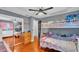Cozy bedroom with a bunk bed, ceiling fan, and large mirrored closet at 1965 Avenue F Sw, Winter Haven, FL 33880