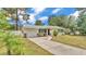 Charming home features a well-maintained front yard and attached garage with stone accents at 1965 Avenue F Sw, Winter Haven, FL 33880