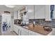 Well-lit kitchen showcasing granite countertops, farmhouse sink, and modern appliances at 1965 Avenue F Sw, Winter Haven, FL 33880