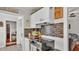 Practical kitchen with white cabinetry, modern appliances, and a tiled backsplash for a clean and functional space at 1965 Avenue F Sw, Winter Haven, FL 33880