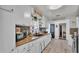Charming kitchen with white cabinets, dark hardware, subway tile backsplash, and modern appliances at 1965 Avenue F Sw, Winter Haven, FL 33880