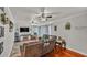 Comfortable living room featuring hardwood floors, ceiling fans, and a cozy seating area at 1965 Avenue F Sw, Winter Haven, FL 33880