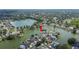 Aerial view of a home surrounded by mature trees and lush landscaping by a lake at 2015 Hatteras Pt, Lakeland, FL 33813