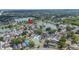 Aerial view of homes bordering a lake in a lush, green neighborhood at 2015 Hatteras Pt, Lakeland, FL 33813