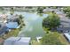 Aerial view showcasing a serene lake surrounded by beautiful homes and verdant landscapes at 2015 Hatteras Pt, Lakeland, FL 33813