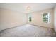 Neutral bedroom with carpet and windows showcasing a water view at 2015 Hatteras Pt, Lakeland, FL 33813