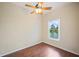 Bedroom with ceiling fan and tranquil lake view at 2015 Hatteras Pt, Lakeland, FL 33813