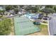 Aerial shot of a tennis court, pool, and clubhouse amenities in a well-maintained community at 2015 Hatteras Pt, Lakeland, FL 33813