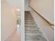 Inviting entryway featuring tile flooring and a staircase with wooden handrail, complemented by neutral paint tones at 2015 Hatteras Pt, Lakeland, FL 33813