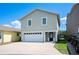 Two story home featuring an attached two car garage, concrete driveway and manicured landscaping at 2015 Hatteras Pt, Lakeland, FL 33813
