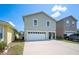 Two-story home with a two-car garage and neutral-colored exterior at 2015 Hatteras Pt, Lakeland, FL 33813
