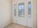 A front door with a decorative glass insert and sidelights, offering a bright and welcoming entrance at 2015 Hatteras Pt, Lakeland, FL 33813