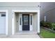 A close-up view of the front door, showing a glass door with decorative panels and a white frame at 2015 Hatteras Pt, Lakeland, FL 33813