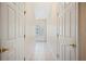 Hallway with tile floors and white walls with a door with decorative glass, offering a grand entrance at 2015 Hatteras Pt, Lakeland, FL 33813