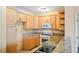 Practical kitchen featuring granite countertops, wooden cabinetry, and essential appliances for everyday cooking at 2015 Hatteras Pt, Lakeland, FL 33813