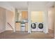 Upstairs bonus room featuring a wet bar and laundry area with washer and dryer at 2015 Hatteras Pt, Lakeland, FL 33813