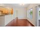 Bright living room with hardwood floors, breakfast bar and sliding glass doors showcasing a water view at 2015 Hatteras Pt, Lakeland, FL 33813
