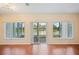 Bright living room with hardwood floors and sliding glass doors showcasing a serene water view at 2015 Hatteras Pt, Lakeland, FL 33813