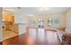 Open-concept living room flows into the kitchen, featuring hardwood floors and an inviting waterfront view at 2015 Hatteras Pt, Lakeland, FL 33813