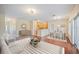 Open-concept living room with hardwood floors, dining area, and kitchen with breakfast bar at 2015 Hatteras Pt, Lakeland, FL 33813