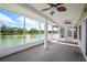 This is a view of the screened-in porch, featuring a water view, ceiling fans, and durable decking at 2015 Hatteras Pt, Lakeland, FL 33813