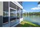 Screened in porch with wood paneling and a beautiful view of the lake and surrounding trees at 2015 Hatteras Pt, Lakeland, FL 33813