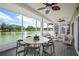 Inviting screened porch with tranquil lake views, dining table, and comfortable seating area at 2015 Hatteras Pt, Lakeland, FL 33813