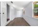 Light-filled bedroom features carpeted floors, neutral walls, and windows overlooking the backyard at 202 W Hancock St, Lakeland, FL 33803