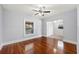 Bedroom features hardwood floors, a ceiling fan, and closet for ample storage at 202 W Hancock St, Lakeland, FL 33803