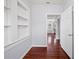 Hallway showcasing built-in shelving, hardwood floors, and freshly painted grey walls at 202 W Hancock St, Lakeland, FL 33803