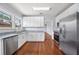 Updated kitchen features white cabinets, granite countertops, and stainless steel appliances at 202 W Hancock St, Lakeland, FL 33803
