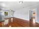 Spacious living room with original hardwood floors, large windows, and soft gray walls at 202 W Hancock St, Lakeland, FL 33803