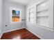 Cozy room featuring hardwood floors, window, and built-in shelving for storage at 202 W Hancock St, Lakeland, FL 33803