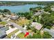 Aerial view of a lakeside home with a pool and lush greenery, showcasing its prime waterfront location at 2103 Sylvester Ct, Lakeland, FL 33803