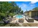 Outdoor patio with a fire pit, barbecue grill, dining table, and comfy sofa at 2103 Sylvester Ct, Lakeland, FL 33803