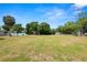 Expansive lot with a shelter, utility shed, and lake views, creating a unique outdoor space at 2103 Sylvester Ct, Lakeland, FL 33803
