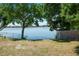 Backyard with a lake view, surrounded by lush trees, offering serene waterfront scenery at 2103 Sylvester Ct, Lakeland, FL 33803