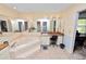 Bathroom features a jacuzzi tub, shower, and vanity with a chair at 2103 Sylvester Ct, Lakeland, FL 33803