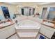 This bathroom features a jacuzzi tub and double sinks with nice countertop at 2103 Sylvester Ct, Lakeland, FL 33803