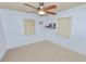 This simple bedroom features carpet and a ceiling fan at 2103 Sylvester Ct, Lakeland, FL 33803