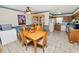 Dining room boasts tile floors, adjacent kitchen with wood cabinets, and ceiling fan at 2103 Sylvester Ct, Lakeland, FL 33803